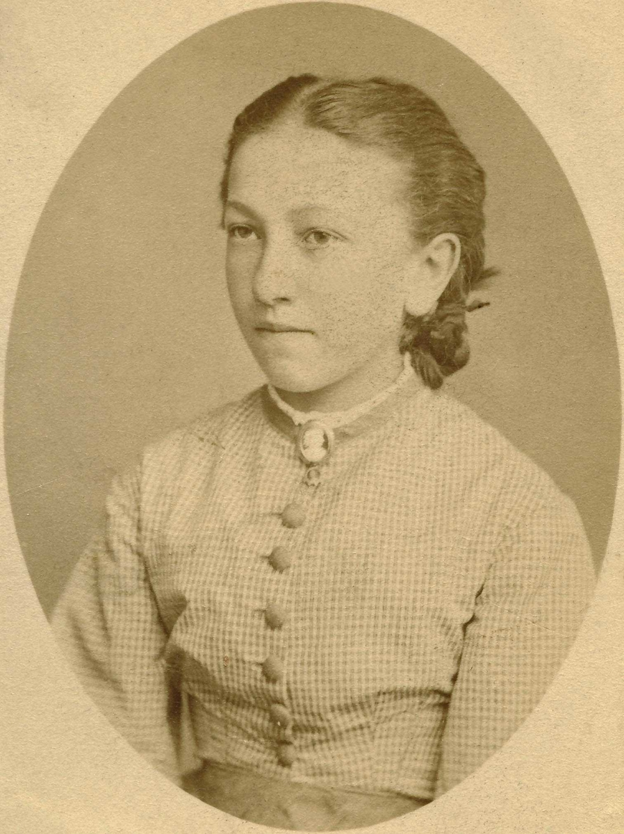 Portrett av ung Bergitte Brodtkorb senere Esbensen i lys kjole. Ca 1870-1880.