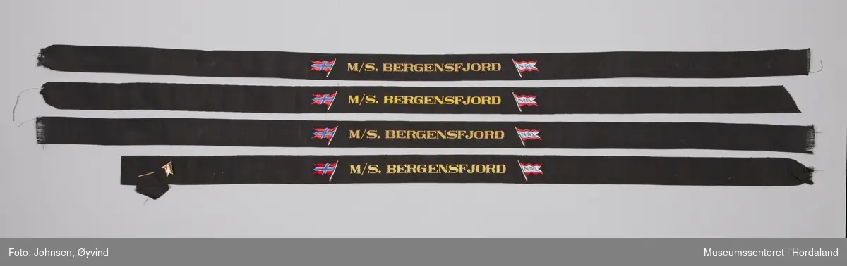 Sort luebånd M/S. Bergensfjord med det norske flagget og NAL flagget.