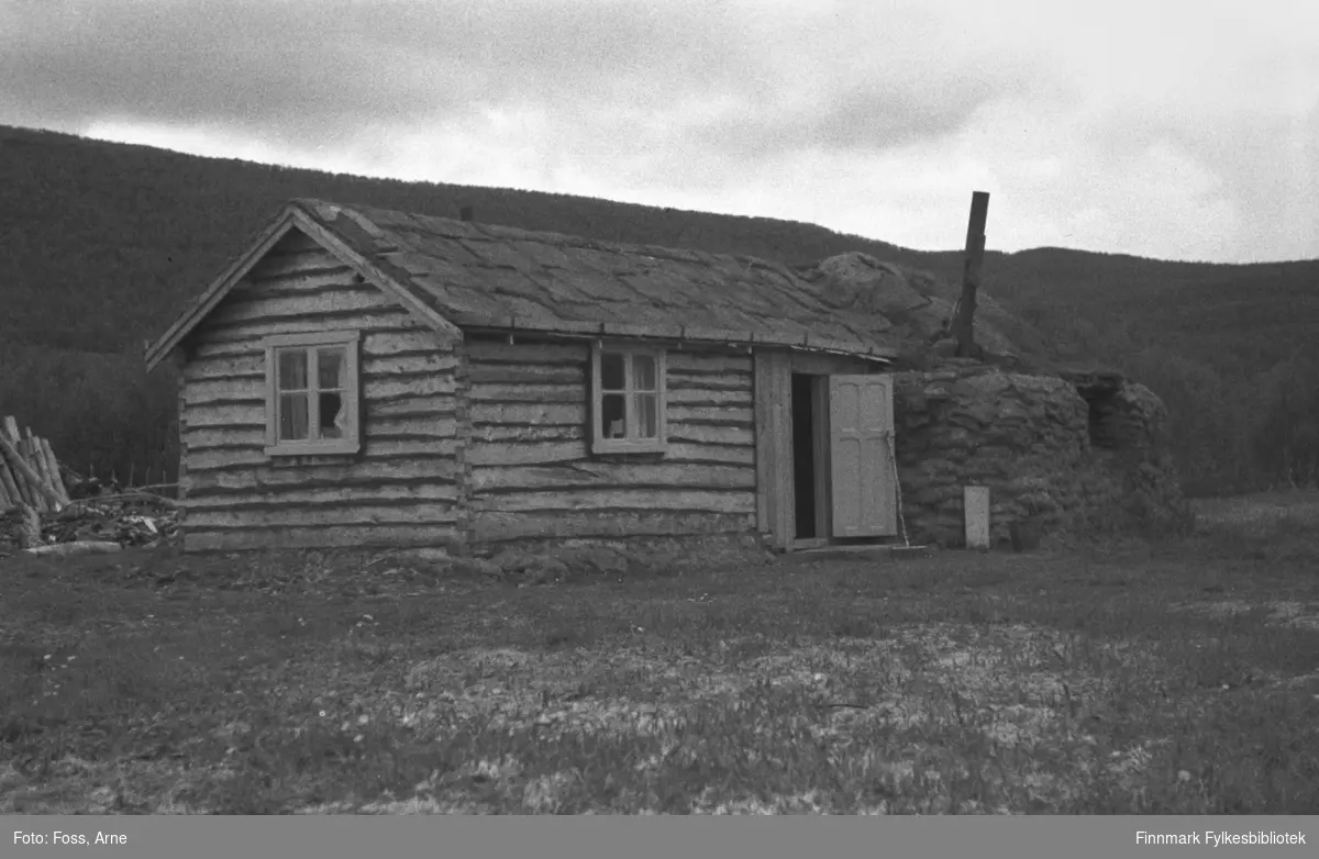 Et tømmerhus med fjøs  i andre enden. Fjøsdelen er bygget av torv på samme vis som gammer ble bygd i Finnmark. Slike midlertidige kombinasjonshus var det mange av inntil gjenreisningen var ferdig, og mange av disse stod i mange år etter krigen.
