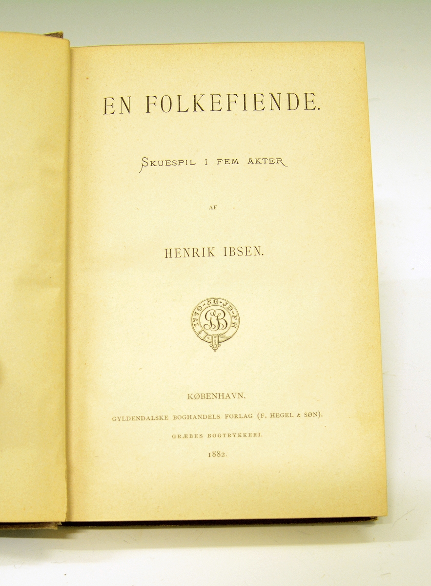 Ibsen, Henrik: En folkefiende. Brunt helshirtingsbind med preget dekor i gull, helt gullsnitt. 
Førsteutgave 1882.