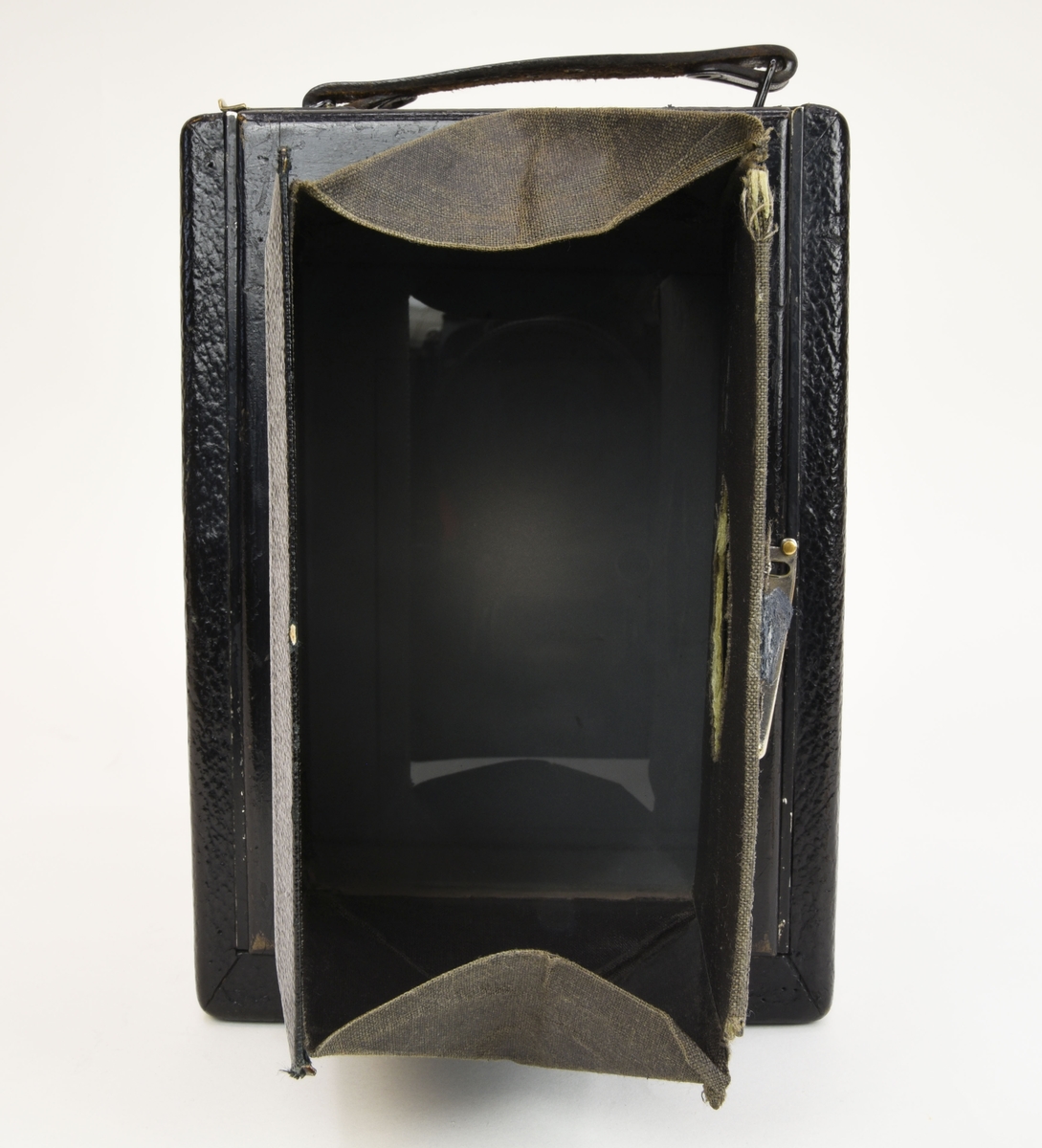 En bälgkamera (:3) som tar glasnegativ i storlek 9 x 12 cm och dess tillhörande kameraväska (:4).

Kamerakroppen är gjord av trä men själva kamerakomponenterna är gjorda av metall och glas. Objektivet är ett Carl Zeiss Jena av Tessar modell 65mm f 4,5. Slutaren av typen Compur. Kameran är utvändigt klädd med konstläder.

Kameraväskan (:4) verkar bestå av pappskivor som är klädda med svart konstläder. Invändigt är den klädd med röd textil. Väskan har ett enklare lås av metall.