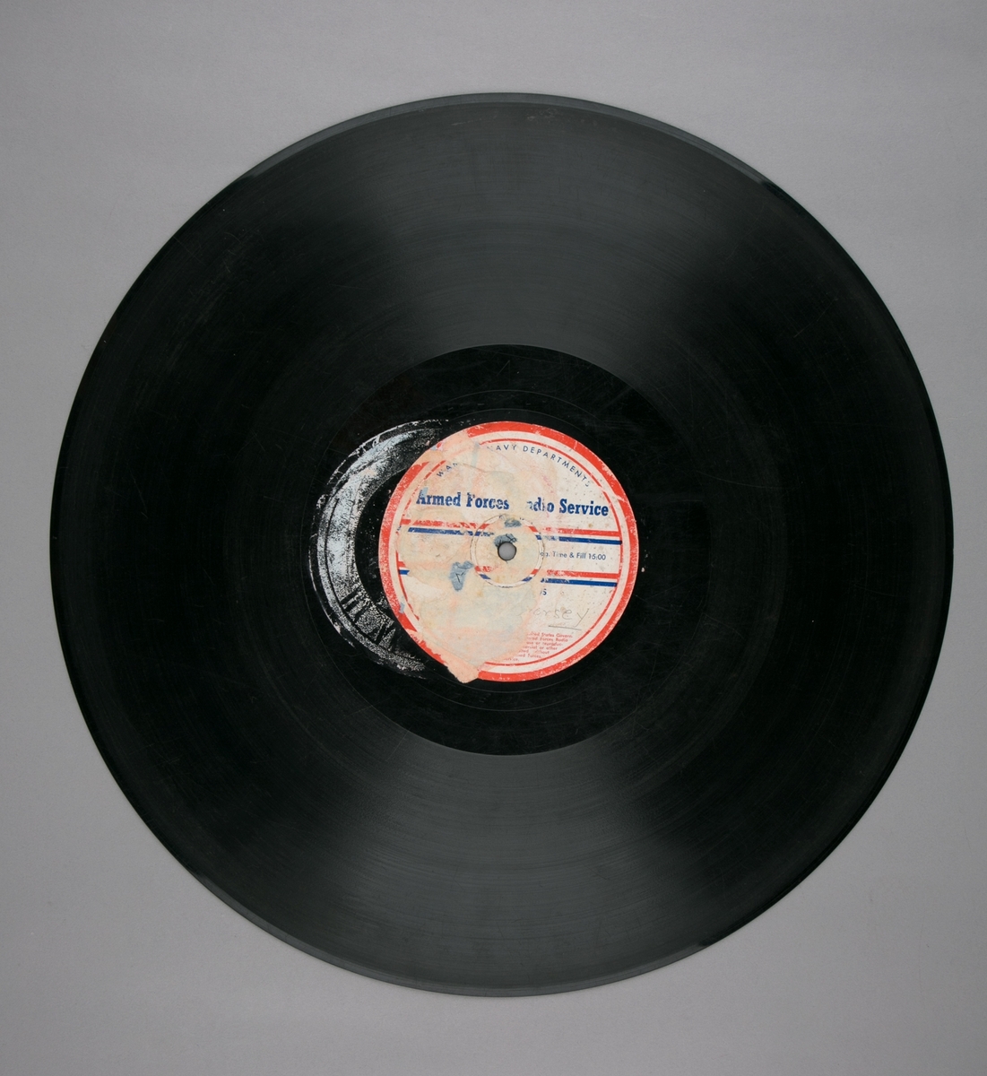 Grammofonplatesamling. LP-plate med tittel "Armed Forces Radio Service" utgitt av War and Navy Departements. Plate i svart vinyl spilles på platespiller med 33 1/3 omdreininger i minuttet (33-plate).