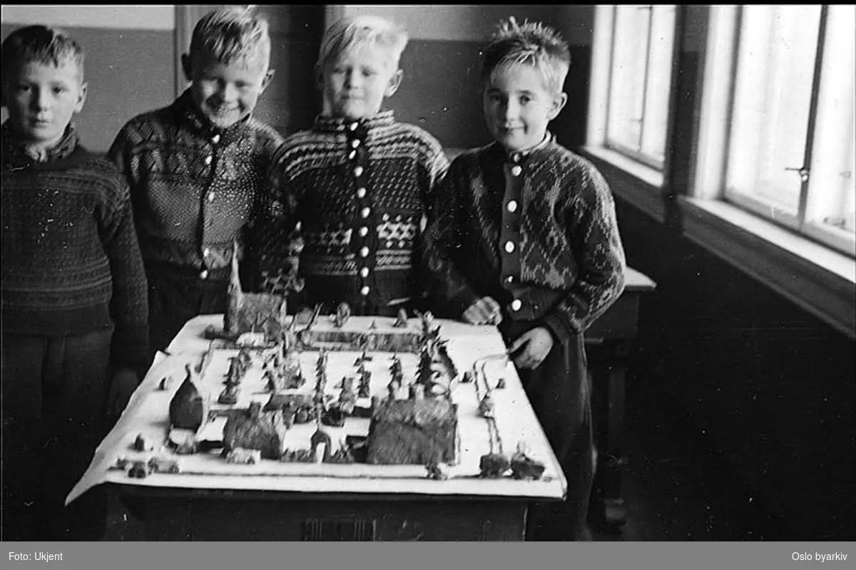 Stolte elever viser fram modell i leire fra lokalmiljøet.(Formingsundervisning). Albumtittel: "Sofienberg skole femti år - første september 1933."