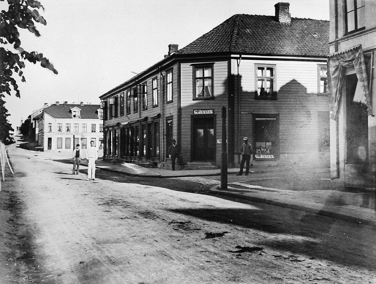 Simensgården. G. Jensen Kolonialforretning i Strandgata, Hamar. Satt opp i 1850, gården brant ned i 1946. I dag ligger "Casa Blanca" her. 