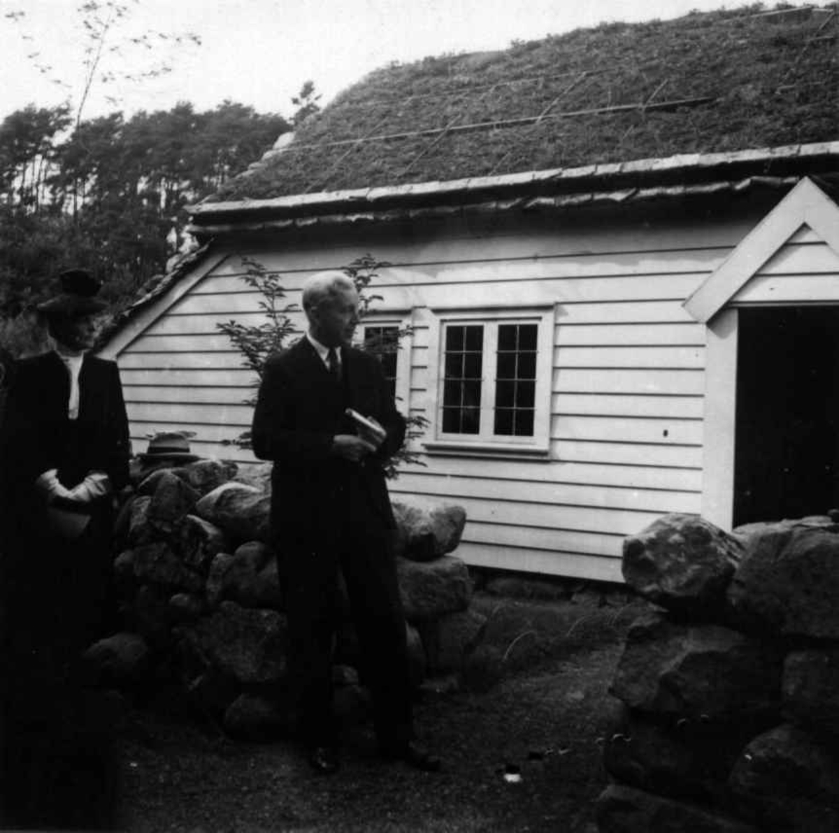 Foran Lendestua  på Norsk Folkemuseum, bygning nr. 91 på åpningsdagen den 30. august 1939.
Professor Sem Sæland taler ved innvielsen.
Stua kommer fra Lende, Time på Jæren.