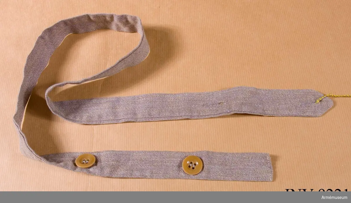 Skärp till klänning m/1931, SLK. Av grått bomullstyg med knäppning med två knappar.