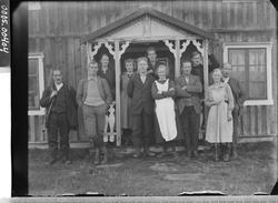 Gruppebilde av fem kvinner og seks menn  i en inngangsportal